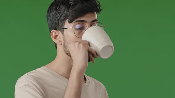 Close Up Portrait of Handsome Young Arabian Guy Millennial Indian Man Drink Coffee Hot Herbal Tea