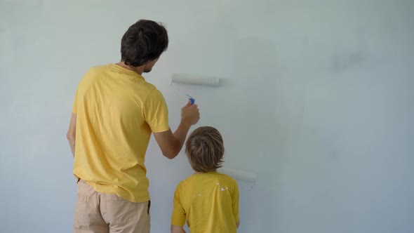 A Young Man and His Son are Doing a Walls Renovation in Their Home