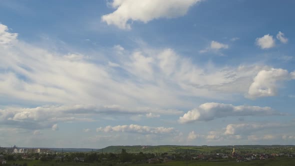 Time Lapse Footage of Fast Moving White Puffy Clouds on Blue Clear Sky Over Rural Area