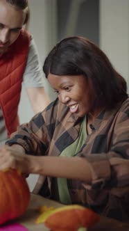 A Handsome Young Lady is Carving the Pumpkin