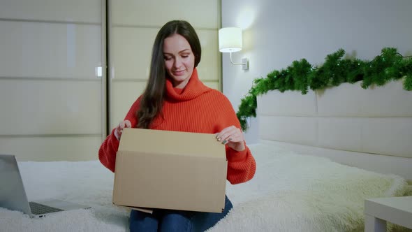 Happy Amazed Young Girl Consumer Holding Opening Cardboard Box Sit Sofa Home