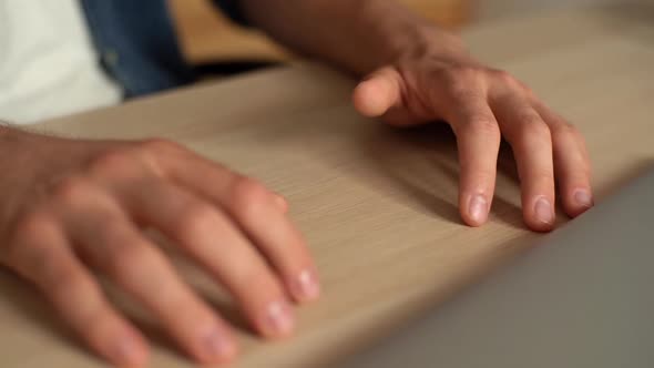 Closeup Hands of Unrecognizable Anxiously Young Man Nervously Tapping Thumb on Table in Home Office