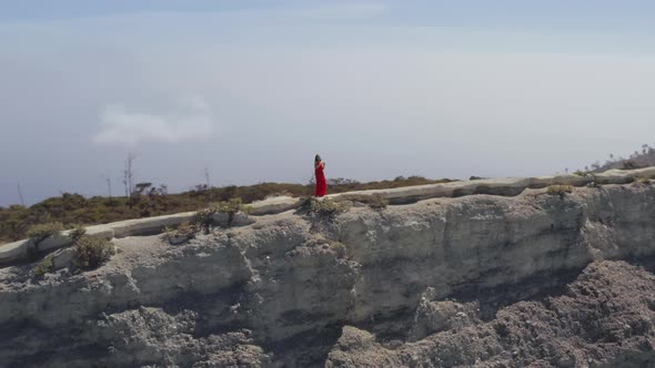 Drone View of Woman in Stylish Dress Dancing on Mountain Top