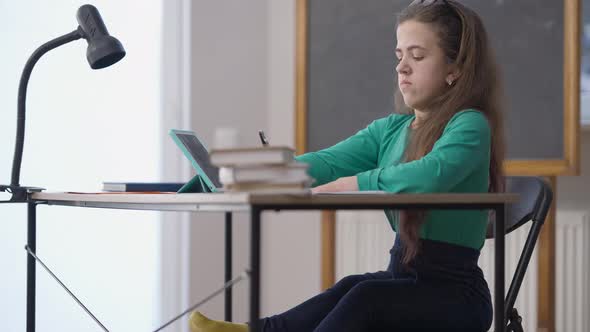 Stressed Nervous Little Person Crumpling Paper Sitting at Desk in College Classroom