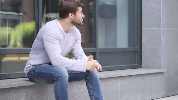 Thumbs Up By Handsome Man Sitting Outside Office Window