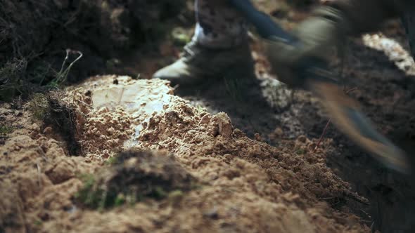 One Soldier Digs a Trench in a Pine Forest