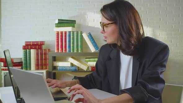 Deadline Concept  a Woman in the Office Takes Off Her Glasses and Drops Her Head in Her Hands