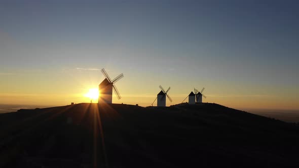 Aerial view of windmills in the countryside in Spain at sunrise