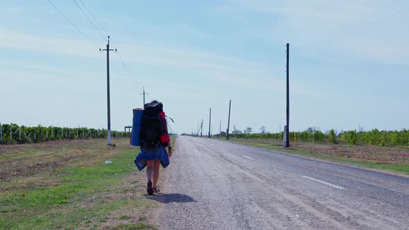 Female Hitchhiker Backpacker Hiker on Roadside