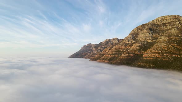 Aerial view of False bay covered in low cloud sunrise, Simonstown, Cape Town, South Africa.