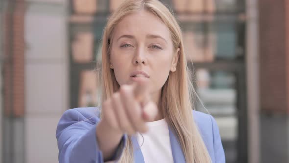 Young Businesswoman Pointing with Finger Outdoor