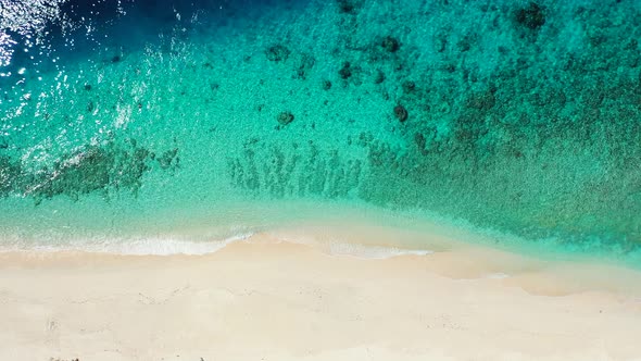 Abstract sea and sandy beach background. Overhead aerial, perfectly clear ocean water with corals. L