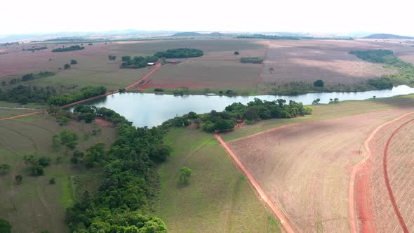Aerial shot of the countryside of Goias with a lake and farming zones.