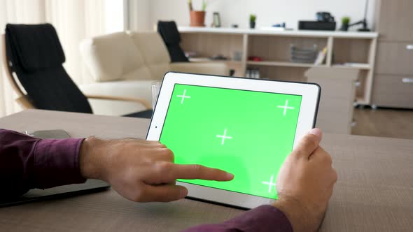 Man Working on Digital Tablet PC with Green Screen Mock Up