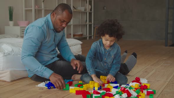 Father and Son Playing Developing Game at Home