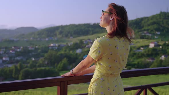 Happy Tourist Woman is Enjoying Her Summer Vacation in Ecological Area in Highland