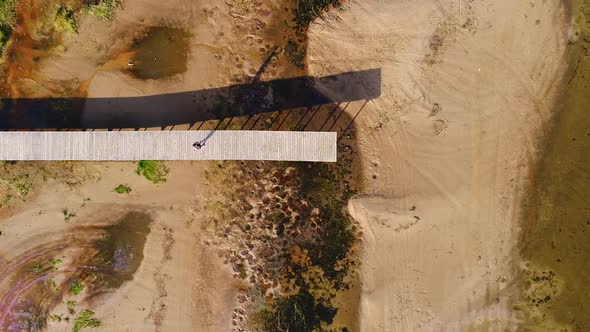 Aerial view of man standing on the edge of wood pier, Estonia.