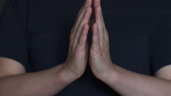 Woman Praying, Creates and Holds a Clot of Vital Energy in Her Palms. Glowing Lights in Woman Hands