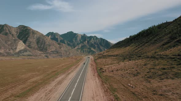 Mountains of Altai with traffic cars on Chuya highway