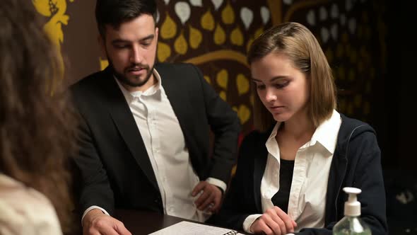 A man and a woman consult with a specialist about the types of massage