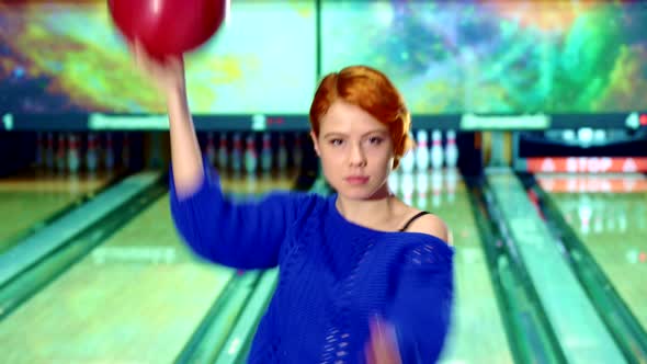 Girl Spins with Bowling Ball in Her Hands