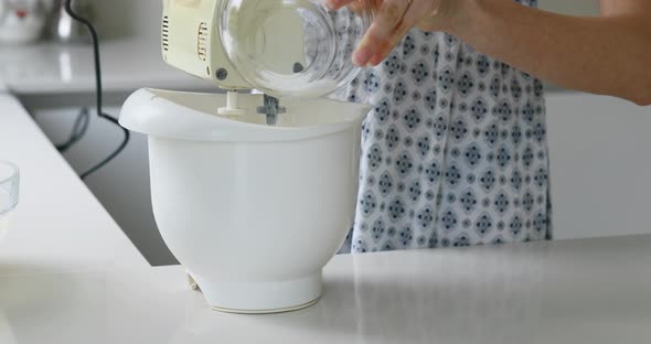 gorgeous woman pours sugar while cooking