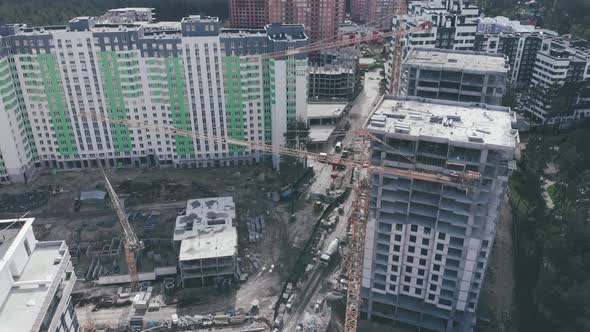 Construction site with new buildings and high cranes. Modern residential complex under construction