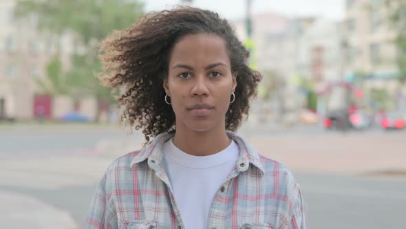 Portrait of African Woman Looking at the Camera Outdoor