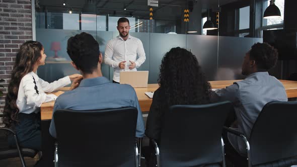 Young Team Leader Make Presentation in Conference Room to Multiracial Employees Confident Male