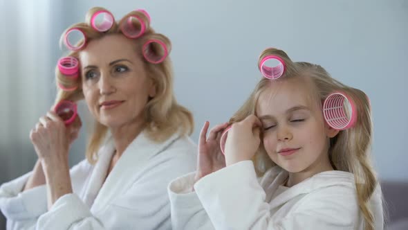 Mature Lady and Little Girl Rolling Hair Together Morning, Beauty and Hairstyle