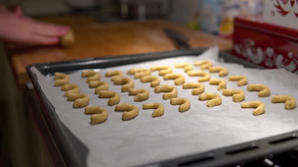 A Man Kneads Raw Cookie Dough and Makes Christmas Cookies, Puts Them on a Pan. A Close Up Detail.