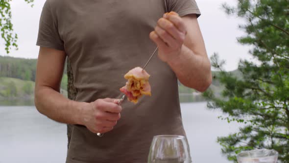 Man Preparing Kebab for Picnic by the Lake