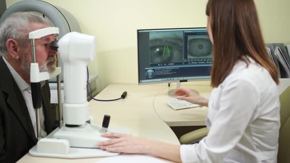 Ophthalmologist Examination of Elderly Man on Corneo Topographer