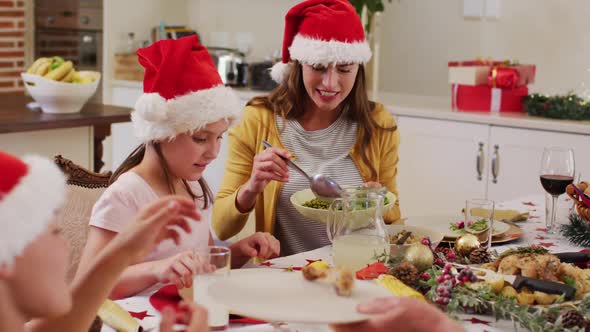 Caucasian woman serving food to her daughter