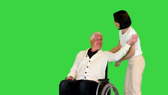 Young Woman Finally Taking Her Disabled Father in a Wheelchair Home on a Green Screen Chroma Key