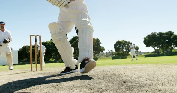 Batsman playing a defensive stroke during cricket match