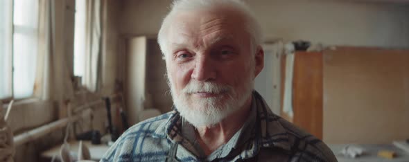 Portrait of Senior Sculptor in Workshop