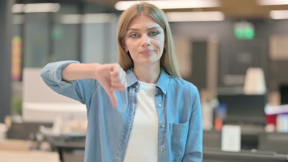 Thumbs Down Gesture By Young Woman