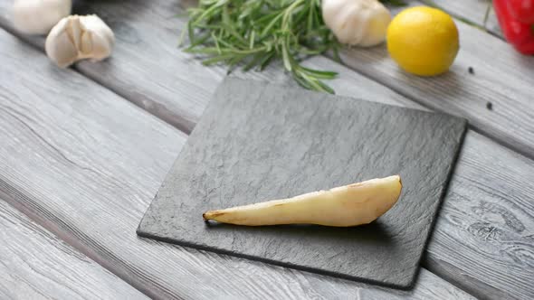 Tongs Put Pear Onto Board