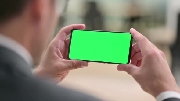 Businessman Watching Smartphone with Chroma Screen