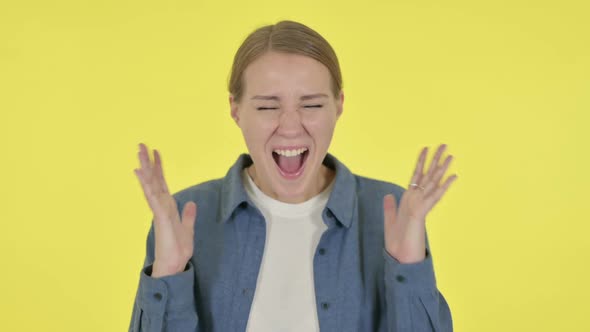 Young Woman Shouting Screaming on Yellow Background