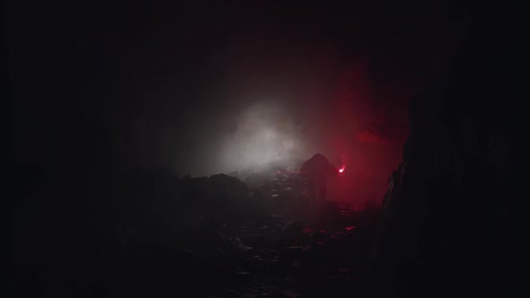 Silhouette Of A Geologist Examining Dark Cave