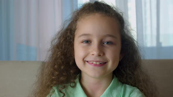 Portrait Honey Little Girl Smiling Child Looking at Camera are Sitting on the Couch at Home Cute Kid