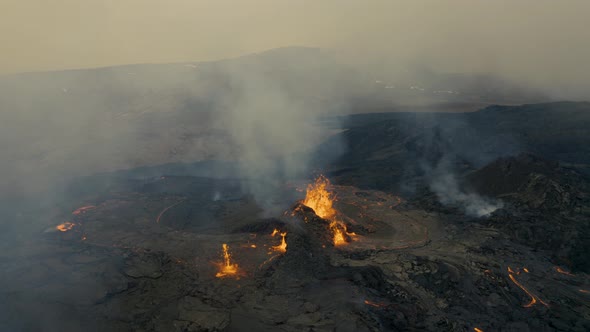 Aerial view of Volcano magma coming through a crater fume in the earth surface