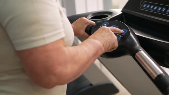 Eldest Woman of Retirement Age Runs on a Treadmill in the Gym