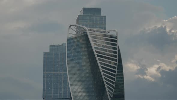 the Facade of a Modern Business Center with a Beautiful Design Against the Backdrop of Cloudy