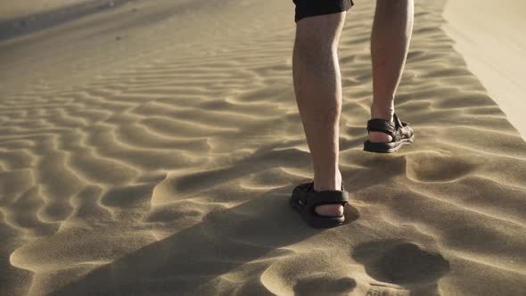 Man Walking In Sand On Dun