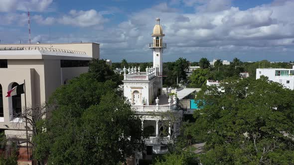 Aerial descent with camera pitch up of the el Minaret mansion on the Paseo de Montejo in Merida, Yuc