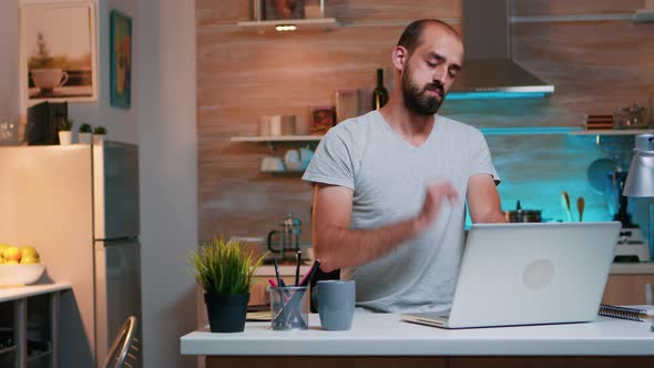 Man Taking a Break From Work and Streching His Neck