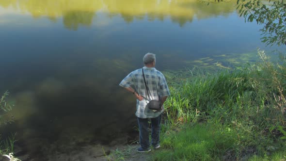 Retired Man Observes Beautiful Nature with River and Forest